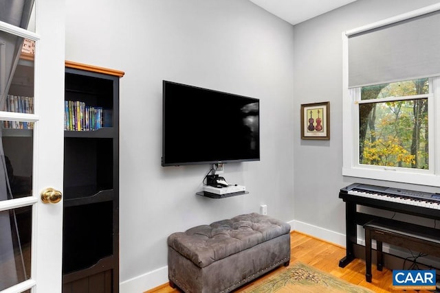 living area featuring wood finished floors and baseboards