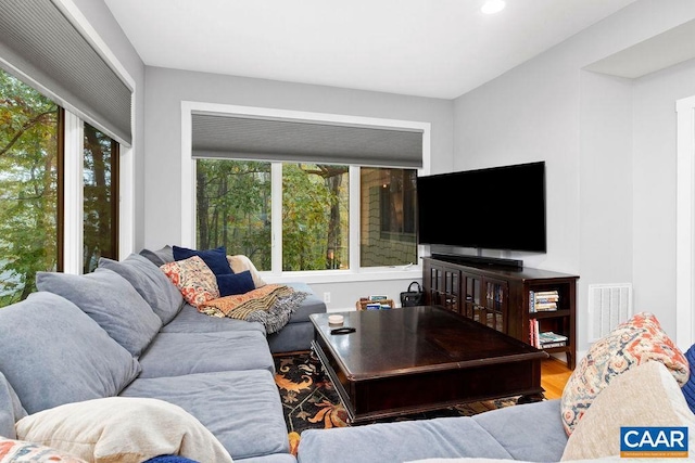 living area featuring recessed lighting, visible vents, and wood finished floors