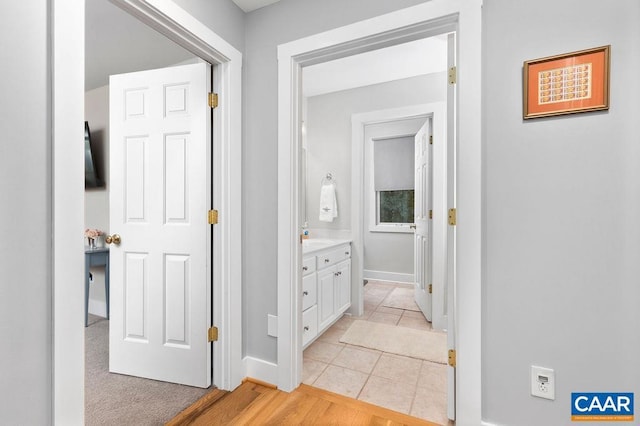 corridor with light tile patterned floors