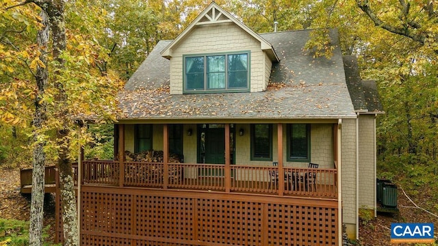 view of front of house with a porch and cooling unit