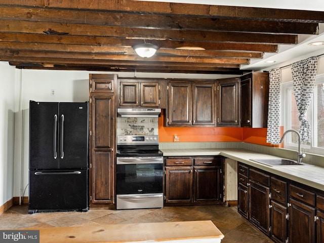 kitchen with electric stove, light countertops, freestanding refrigerator, a sink, and under cabinet range hood