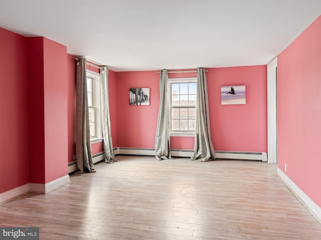 spare room with wood finished floors and baseboards