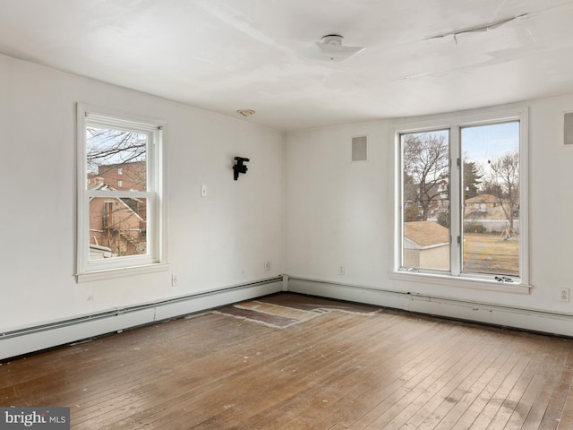 unfurnished room with wood-type flooring