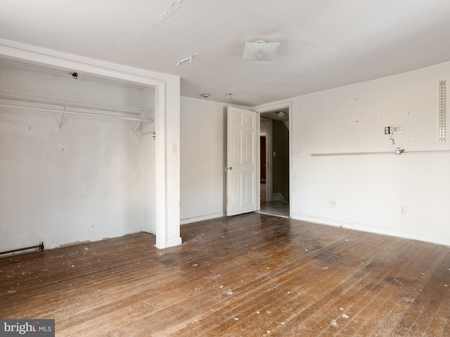 unfurnished bedroom featuring a closet and hardwood / wood-style floors