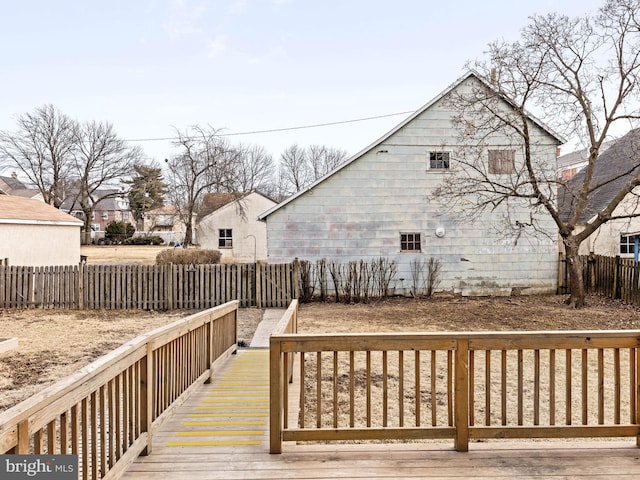 wooden terrace with a fenced backyard