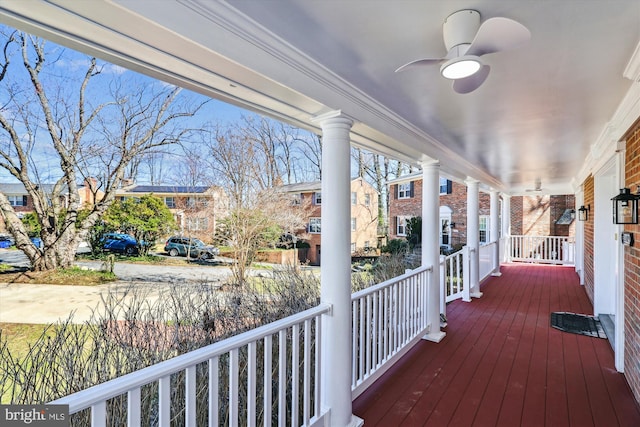 wooden terrace with a porch and a ceiling fan