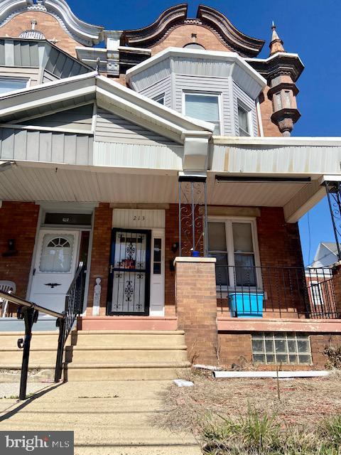 view of front of property featuring covered porch and brick siding