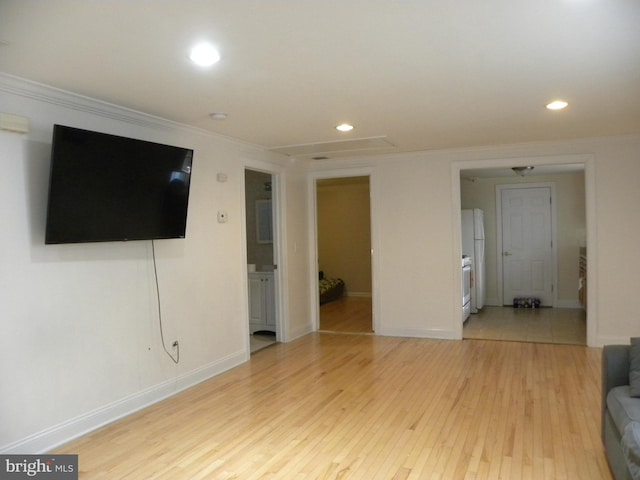 unfurnished living room featuring recessed lighting, light wood-type flooring, and ornamental molding