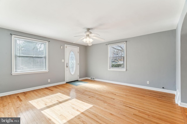 entryway with ceiling fan, light wood-type flooring, visible vents, and baseboards