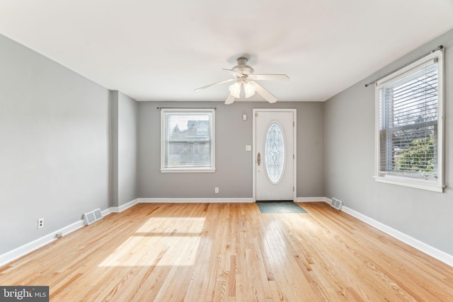 foyer with visible vents, baseboards, and wood finished floors