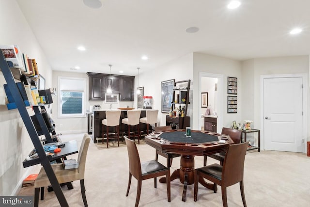 dining space with recessed lighting and light colored carpet