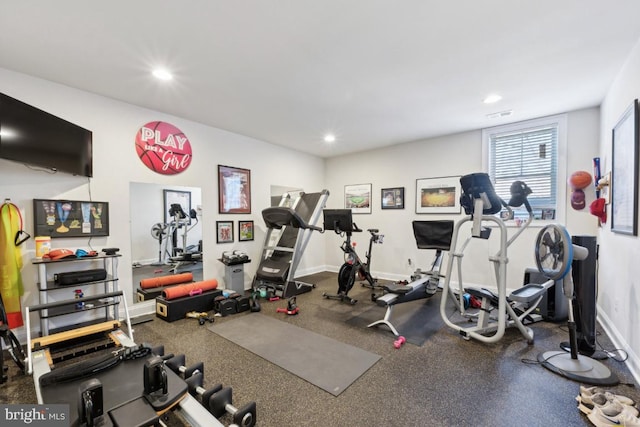 workout area featuring recessed lighting and baseboards