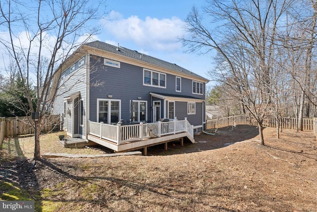 back of property featuring a fenced backyard and a deck