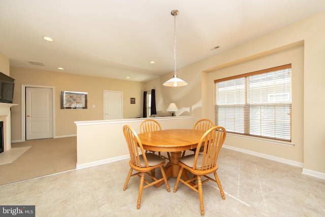 dining room featuring recessed lighting, a fireplace with flush hearth, visible vents, and baseboards