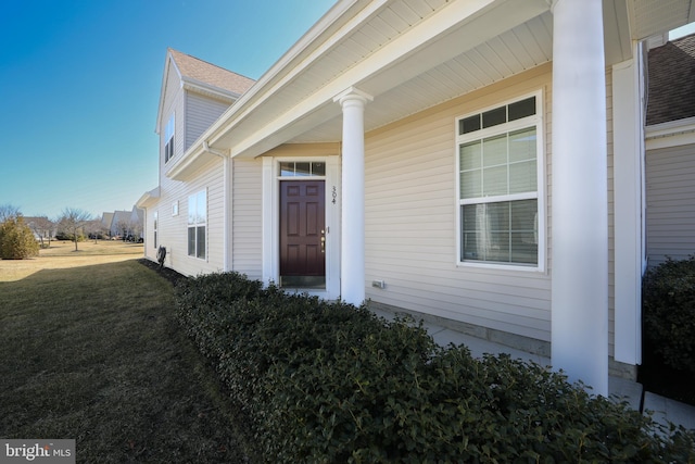 entrance to property featuring a yard