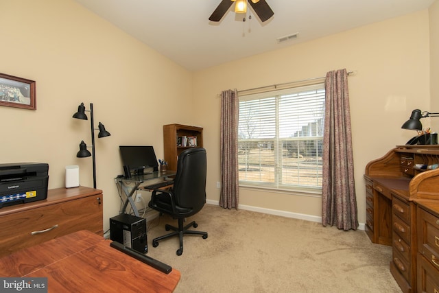 home office featuring light carpet, ceiling fan, visible vents, and baseboards