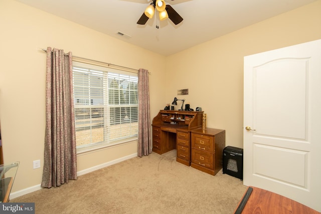 home office featuring light carpet, ceiling fan, visible vents, and baseboards