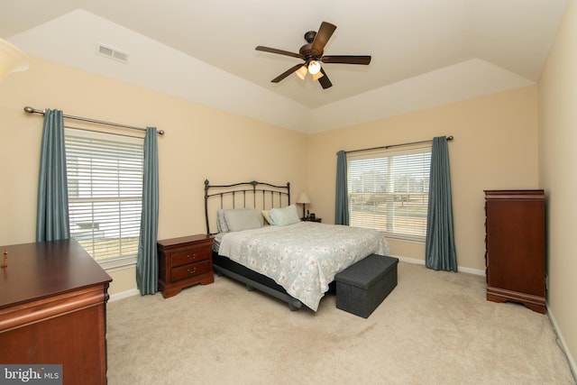 bedroom with visible vents, light carpet, and multiple windows