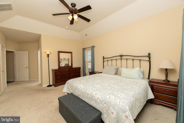 bedroom with light colored carpet, visible vents, vaulted ceiling, ceiling fan, and baseboards