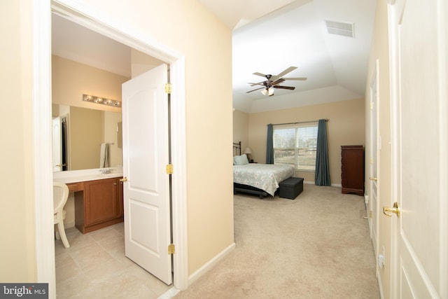 bedroom with lofted ceiling, baseboards, visible vents, and light colored carpet