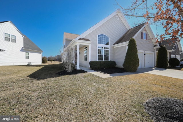 view of front of property with a garage, concrete driveway, and a front lawn