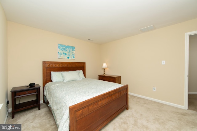 bedroom featuring visible vents, baseboards, and light colored carpet