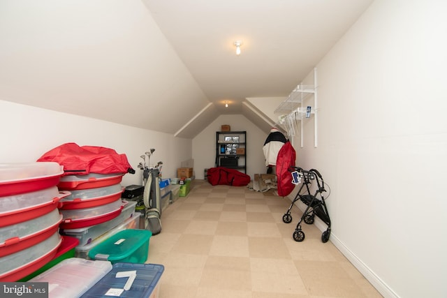 interior space featuring vaulted ceiling, baseboards, and tile patterned floors