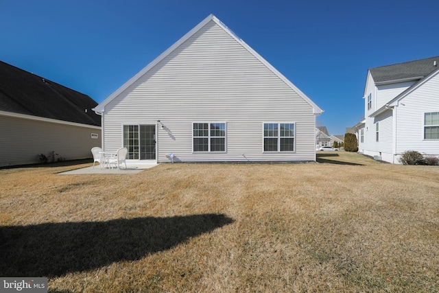 rear view of property with a patio and a yard