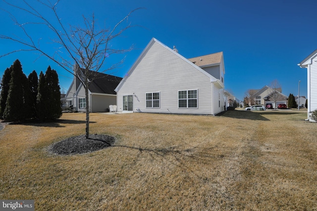 rear view of property with a lawn