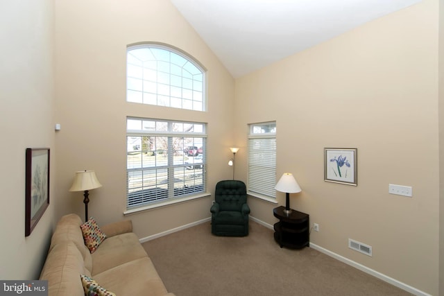 living room featuring high vaulted ceiling, baseboards, visible vents, and carpet flooring