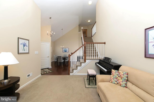 carpeted living area with high vaulted ceiling, a notable chandelier, baseboards, and stairs