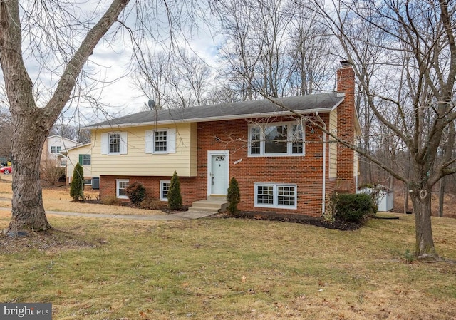12994 Orleans St, Woodbridge, VA 22192 - raised ranch with a chimney, a front yard, and brick siding