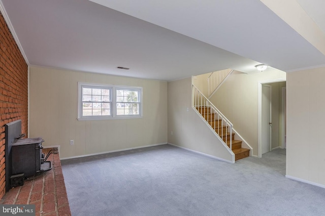 unfurnished living room featuring carpet floors, baseboards, stairs, and visible vents