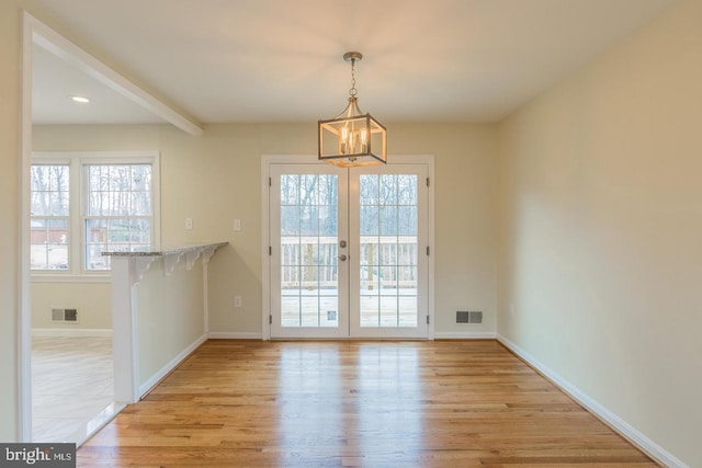 doorway to outside with light wood-type flooring, baseboards, and visible vents