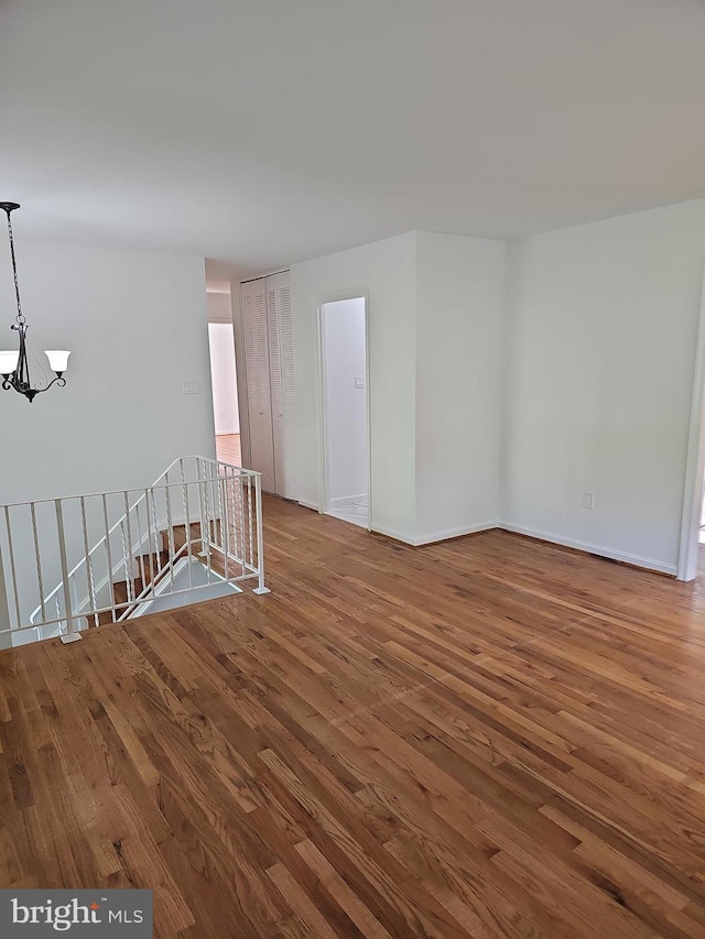 12994 Orleans St, Woodbridge, VA 22192 - unfurnished room featuring a chandelier, wood finished floors, and baseboards