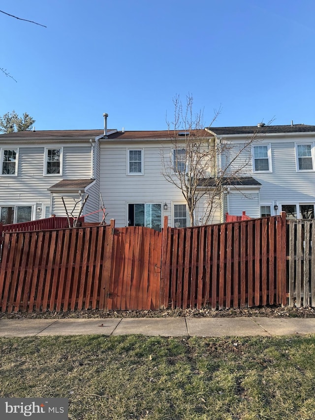 rear view of house with fence private yard