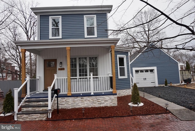 view of front facade featuring covered porch, decorative driveway, and a garage