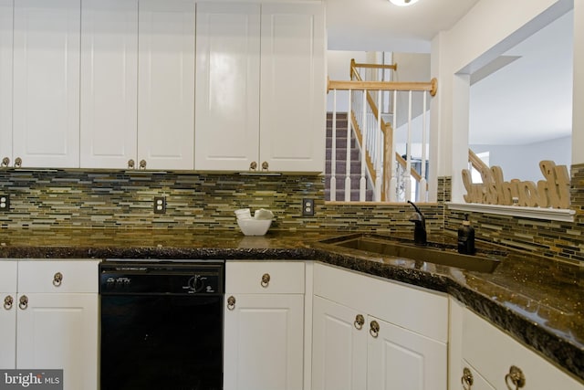 kitchen featuring decorative backsplash, white cabinetry, a sink, dark stone counters, and dishwasher