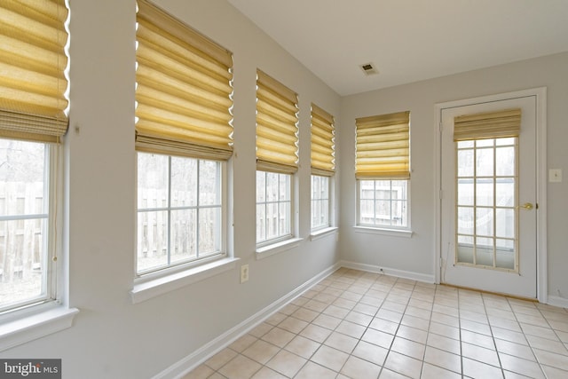 unfurnished sunroom with visible vents