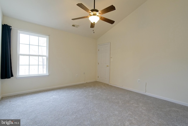 spare room with baseboards, visible vents, a ceiling fan, light colored carpet, and high vaulted ceiling