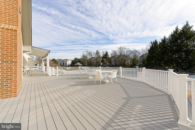 wooden terrace featuring outdoor dining space