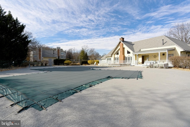 view of swimming pool with a fenced in pool and a patio