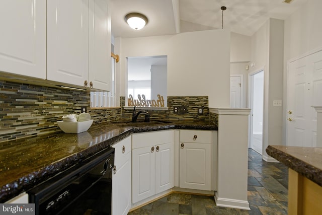 kitchen featuring stone tile floors, backsplash, white cabinetry, a sink, and dishwasher