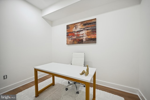 office space featuring baseboards and wood finished floors