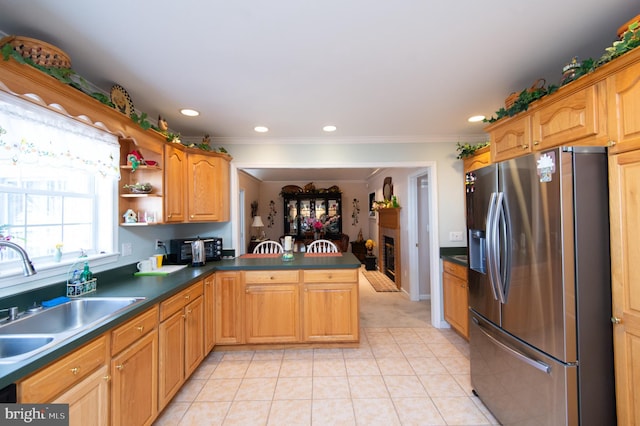 9 Holly Ter, Cambridge, MD 21613 - kitchen with a peninsula, stainless steel fridge with ice dispenser, a sink, crown molding, and dark countertops