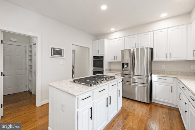 kitchen featuring recessed lighting, light wood-type flooring, and stainless steel appliances