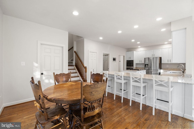 dining area with stairway, recessed lighting, wood finished floors, and baseboards