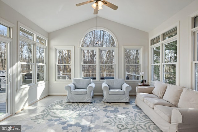 sunroom with ceiling fan and vaulted ceiling