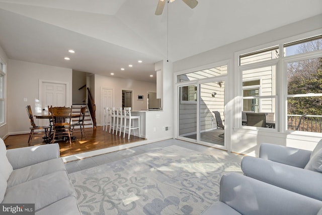 living room featuring vaulted ceiling, stairway, recessed lighting, and baseboards