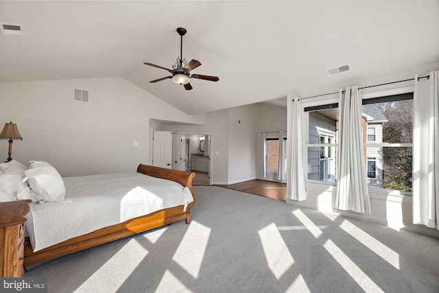 carpeted bedroom with vaulted ceiling, a ceiling fan, and visible vents